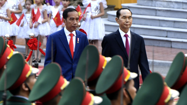 Indonesian President Joko "Jokowi" Widodo, left, and Vietnamese counterpart Tran Dai Quang review the troops on Tuesday.