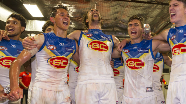 Gold Coast players belt out the song after the massive upset.