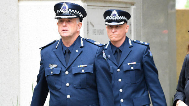 Superintendent Peter Ward (right) and Assistant Commissioner Michael Grainger arrive at the Coroner's Court on Monday.