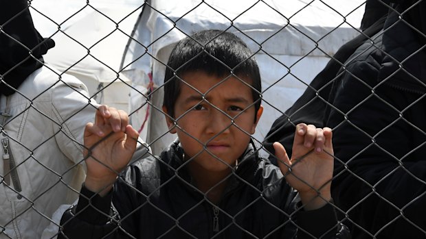 Foreign ISIS wives and children at the fence line of the Foreign section of al-Hawl camp.