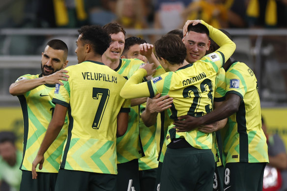 Lewis Miller celebrates a goal with his Socceroos teammates.