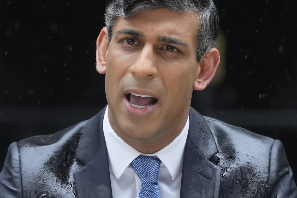 Rishi Sunak on May 22 calling the election as heavy rain falls.