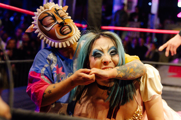 Supersonic (left) and Lady Antoinette grapple during their Sukeban wrestling match.