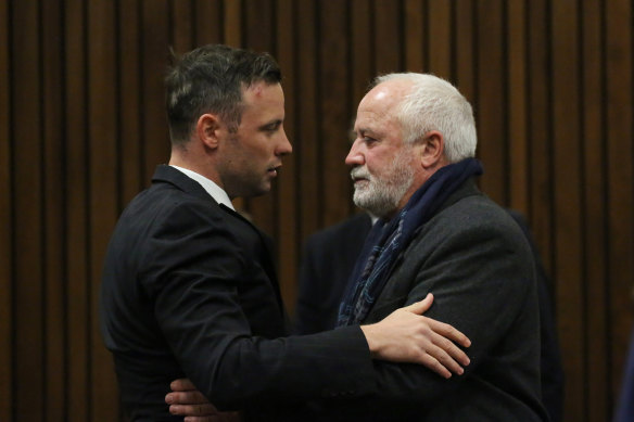 Oscar Pistorius greets his father, Henke Pistorius, in court in 2016. 