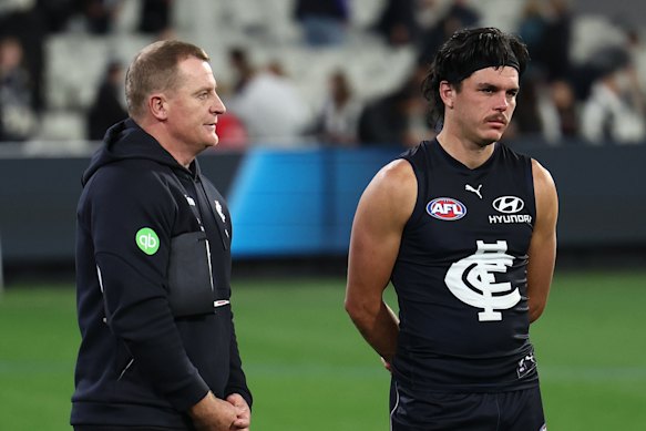 Elijah Hollands (right) with Blues coach Michael Voss after the loss to Collingwood.