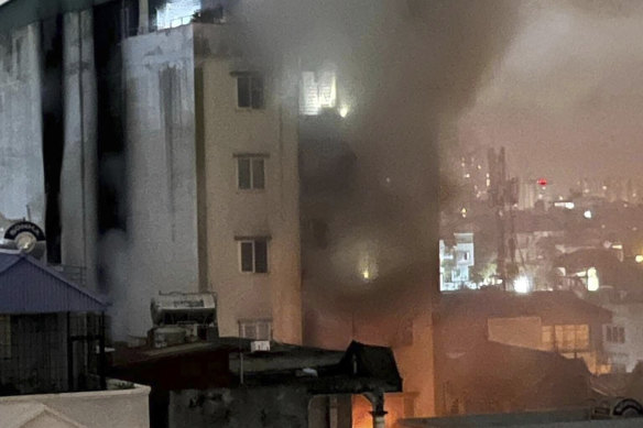 Smoke rises from a building in Hanoi, Vietnam.