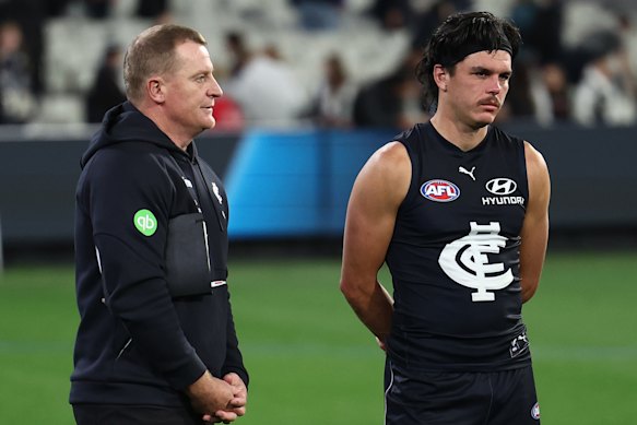 Elijah Hollands (right) with Blues coach Michael Voss after the loss to Collingwood.