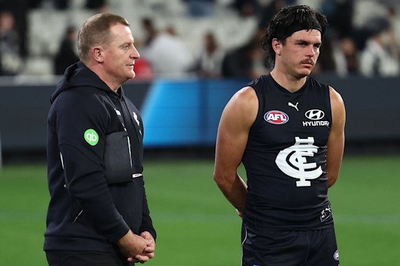 Michael Voss and Elijah Hollands after the Blues’ loss to Collingwood.