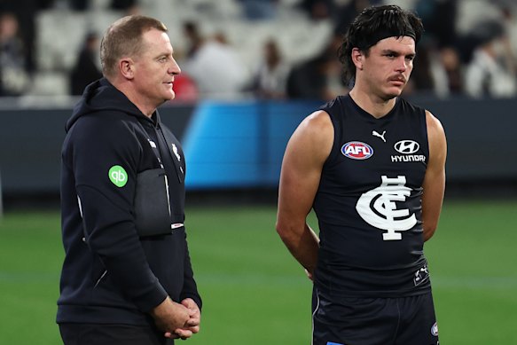 Hollands (right) with Blues coach Michael Voss after the loss to Collingwood.