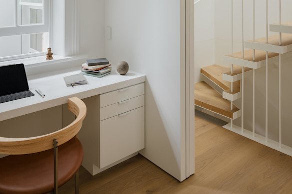 The new staircase, framed by street rods, allows light permeate to the core of the house.