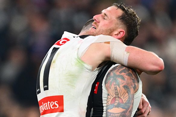 Tim Membrey is consoled by Daniel McStay of the Magpies.