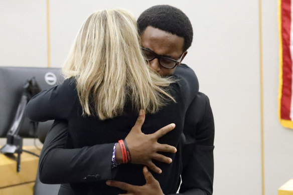 Botham Jean's younger brother Brandt Jean hugs convicted murderer and former Dallas Police Officer Amber Guyger.