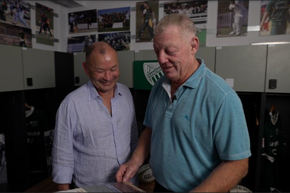 Eddie Jones and Phil Gould look at some old Randwick rugby pictures at Coogee Oval.