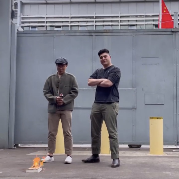 Drew Pavlou, right, with fellow activist Max Mok, staging a book-burning of Xi Jinping’s works at the Chinese consulate in Sydney.