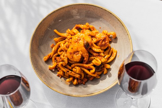 Strozzapreti with prawns, calamari, tomato sauce and black olives.