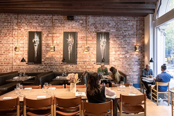 Exposed brick and “scary” artwork in the dining room.
