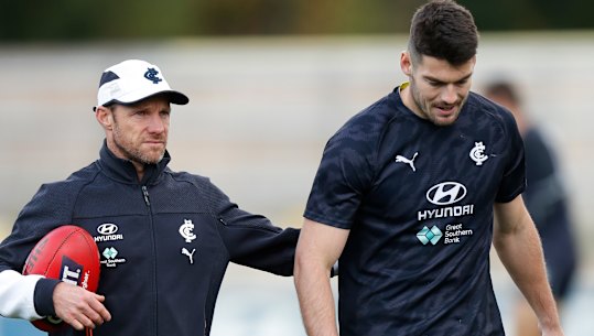 Carlton’s high-performance boss Andrewe Russell with midfielder George Hewett (right).