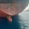 Three men are photographed on an oil tanker anchored in the port of the Canary Islands, Spain.