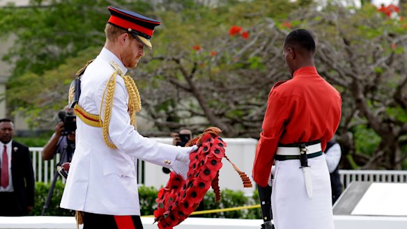 Britain's Prince Harry prepares to lay a wreath at the Suva War Memorial in Suva, Fiji, Wednesday, Oct. 24, 2018. Prince Harry and his wife Meghan are on day nine of their 16-day tour of Australia and the South Pacific.