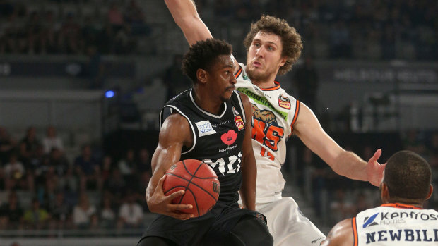 On point: Casper Ware of Melbourne comes under pressure from Robert Loe of Cairns as he drives below the basket.