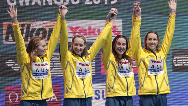 Australia's women's 4x200m freestyle relay team celebrate on the podium as they receive their gold medal at the swimming world championships.