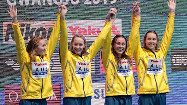 Australia's women's 4x200m freestyle relay team celebrate on the podium as they receive their gold medal at the swimming world championships.