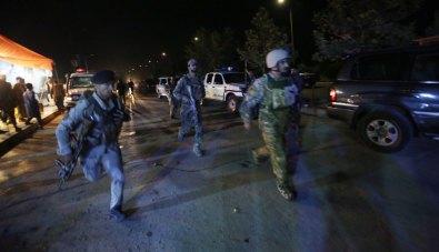Security forces rush to respond to a Taliban attack on the campus of the American University in the Afghan capital Kabul three weeks after Timothy Weeks was kidnapped.