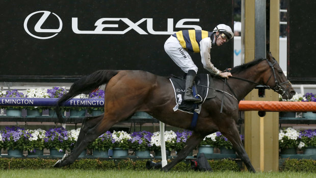 Downdraft passes the post to win the Lexus Hotham Stakes on Derby day.