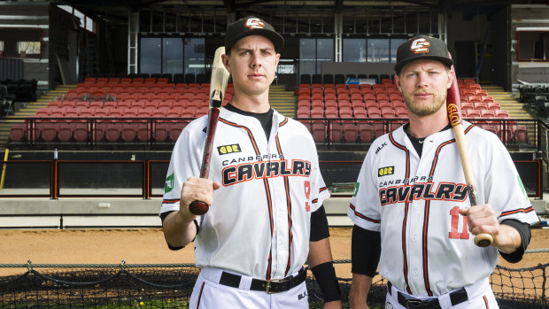 Canberra Cavalry players Robbie Perkins and Kyle Perkins in front of the redeveloped grandstand.