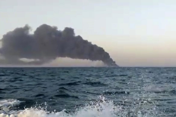 Smoke rises from Iran’s navy support ship Kharg before it sank in the Gulf of Oman.