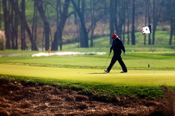 Donald Trump plays golf at his course in Virginia.