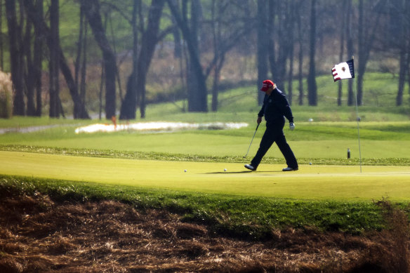 Donald Trump plays golf at his course in Virginia.