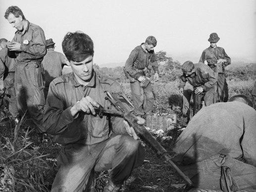 Lt Dave Sabben inspecting his damaged Armalite rifle after the Battle of Long Tan.