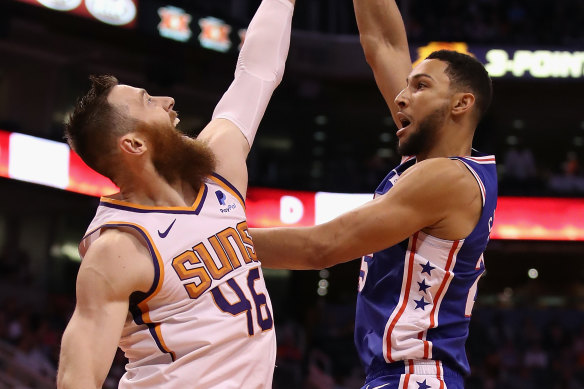 Ben Simmons, right, puts up a shot over Aron Baynes, left, during the first half. 
