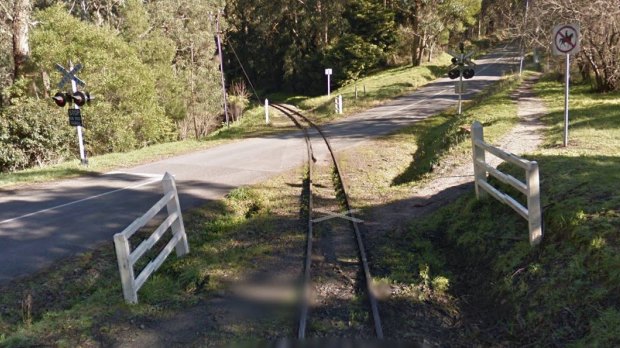 A Google Street view image of the level crossing on School Road in Menzies Creek, where the mini-bus and Puffing Billy collided.