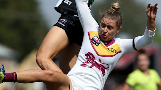 Collingwood's Ash Brazill flies for a mark in the 2019 AFLW season.