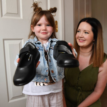 Matilda Hall, 5, with mum Tracey shows off the shoes she'll be wearing to her first day in prep.