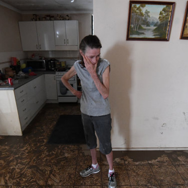 Sue Pollard becomes emotional as she takes in the damage to her Townsville home.