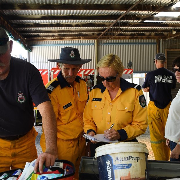 RFS Rainbow Flat firefighters replenish their medical kit at a temporary shed on a RFS member's property after the original shed was destroyed on November 8, 2019.