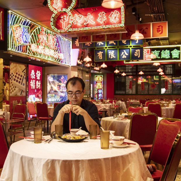 Good Luck Hotpot manager Jack Chen sits in his empty restaurant as the coronavirus crisis keeps people away. 