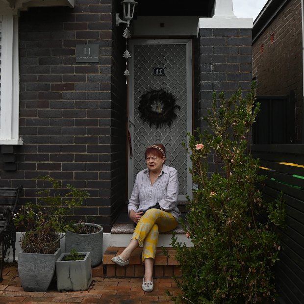 Caroline Gillham-Racz, 75, in front of her home in Campsie, where she has lived for 50 years. “They can take me out in a box,” she says.
