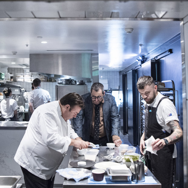 John Fink (centre) watches over as Peter Gilmore prepares a tasting menu
for the new restaurant. 
