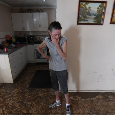Sue Pollard becomes emotional as she takes in the damage to her Townsville home.