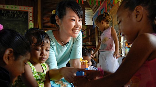 A Japanese aid worker with children on the Pacific island of Tonga. 