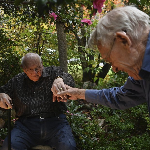 Terry Goulden (left) and his husband John Greenway in their garden at home in Wentworth Falls.