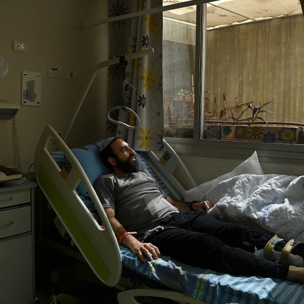 Rabbi Shachar Butzchak being treated in the Soroka Medical Centre for bullet wounds in his leg after being shot during the Hamas attack in Ofakim, Israel.