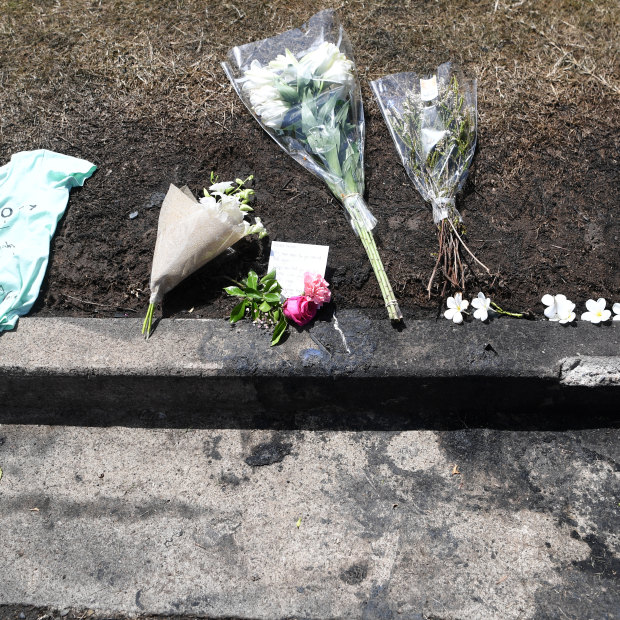 Flowers are left at the scene of a car fire which claimed the lives of a mother and her three young children.