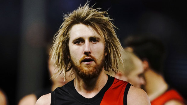 Dyson Heppell leads the Bombers from the field after their heavy loss to the Bulldogs.