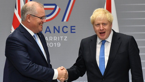Prime Minister Scott Morrison and his UK counterpart Boris Johnson at last year's G7 meeting. We may not shake hands anymore, but can still stand shoulder to shoulder.