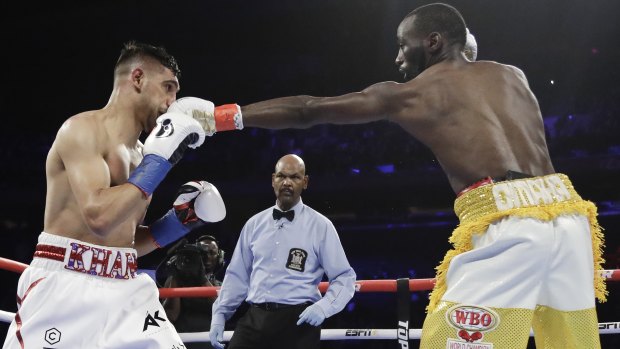 Landing a blow: Terence Crawford, right, connects to the head of England's Amir Khan during the second round of their WBO world champioship bout.